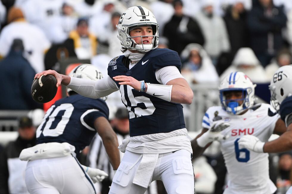 Penn State quarterback Drew Allar (15) throws a pass while being pressured by SMU defensive...