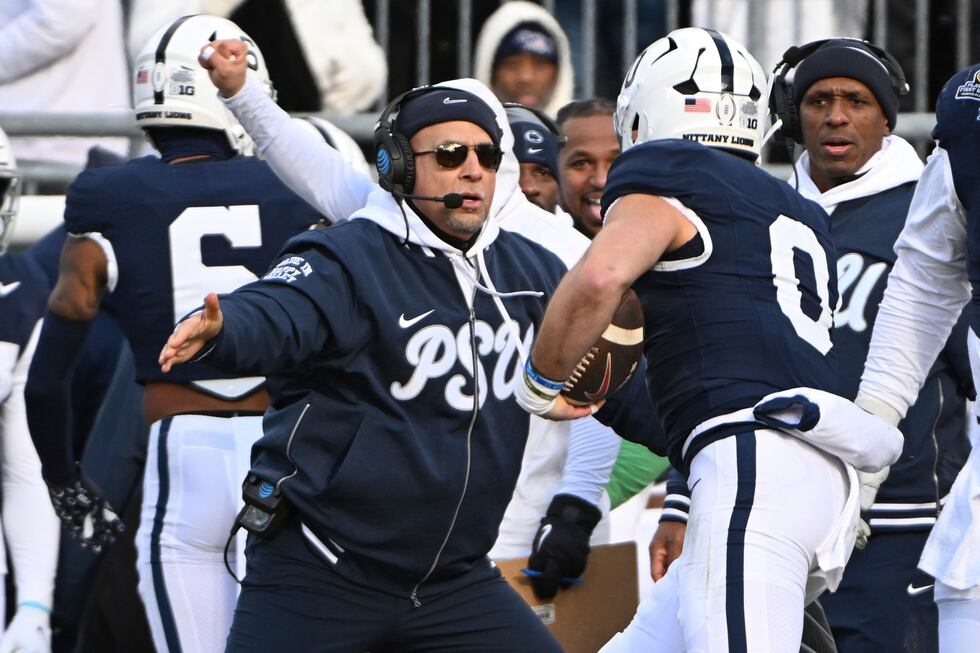 Penn State linebacker Dominic DeLuca celebrates an interception for a touchdown with head...