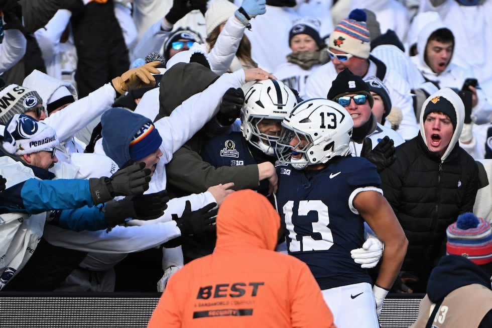 Penn State linebacker Tony Rojas celebrates an interception for a touchdown with Abdul Carter...