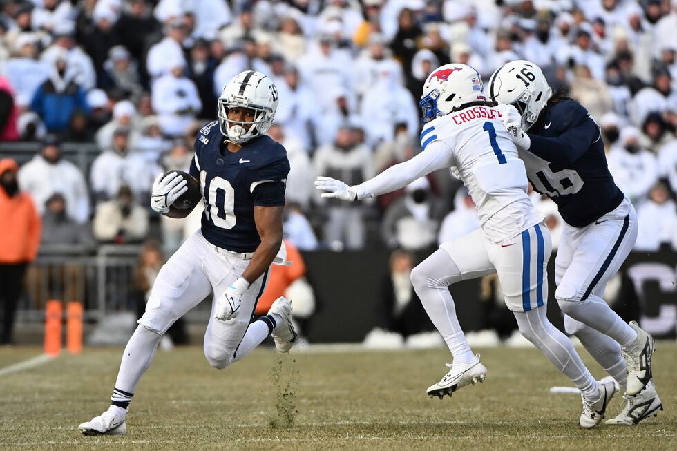 Penn State running back Nicholas Singleton looks to elude SMU safety Brandon Crossley (1)...