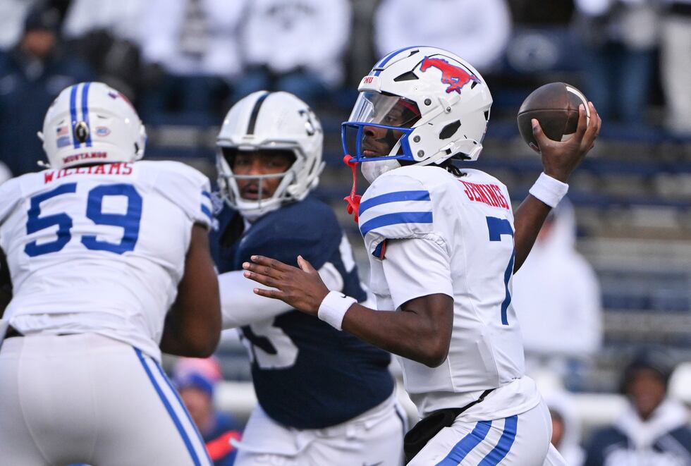 SMU quarterback Kevin Jennings (7) throws a pass while being pressured by Penn State defensive...
