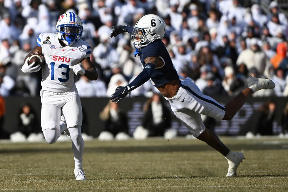 SMU wide receiver Roderick Daniels Jr. (13) looks to elude Penn State safety Zakee Wheatley...